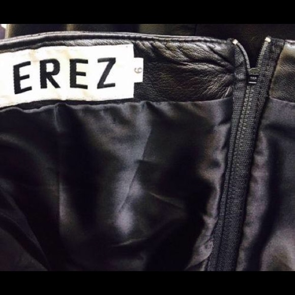 Black leather  strapless dress. 

Features a sweethart plunge cleavage. - Picture 11 of 11